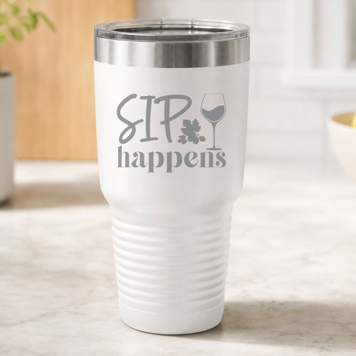 White 30 oz tumbler laser engraved with "Sip Happens", on a kitchen counter