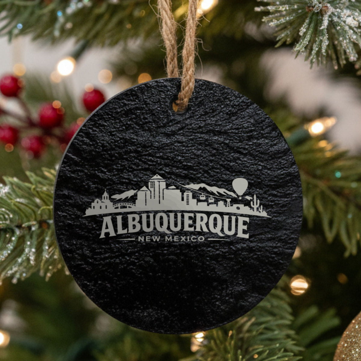 Albuquerque, New Mexico skyline engraved on a round slate Christmas ornament