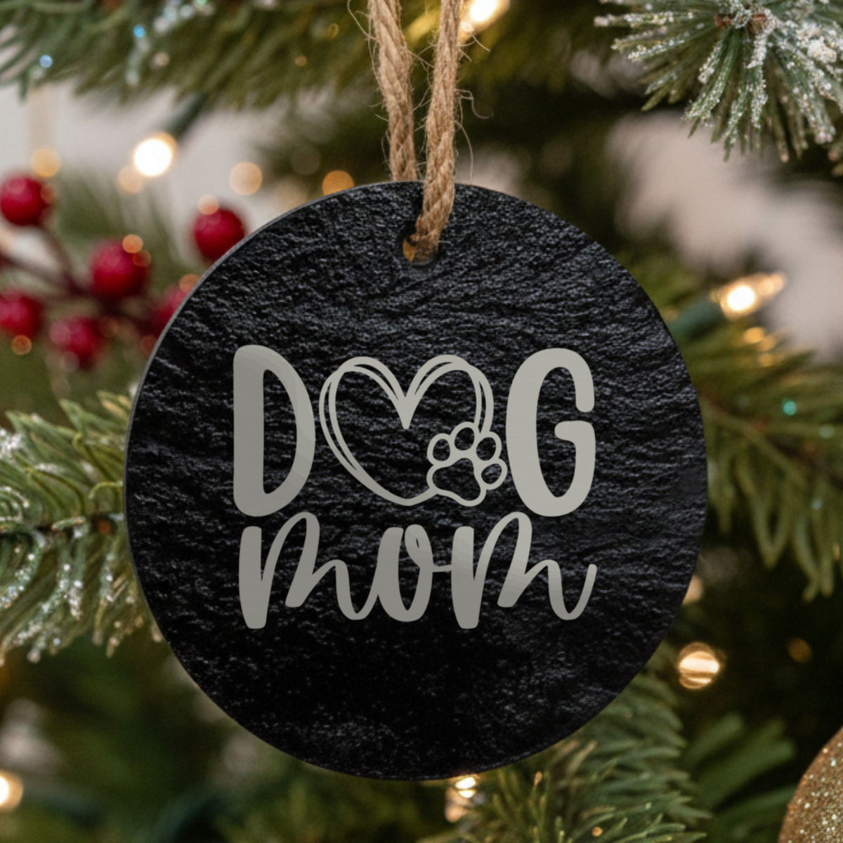 Round black slate Christmas ornament laser engraved in white with a hand drawn Dog Mom heart and paw design