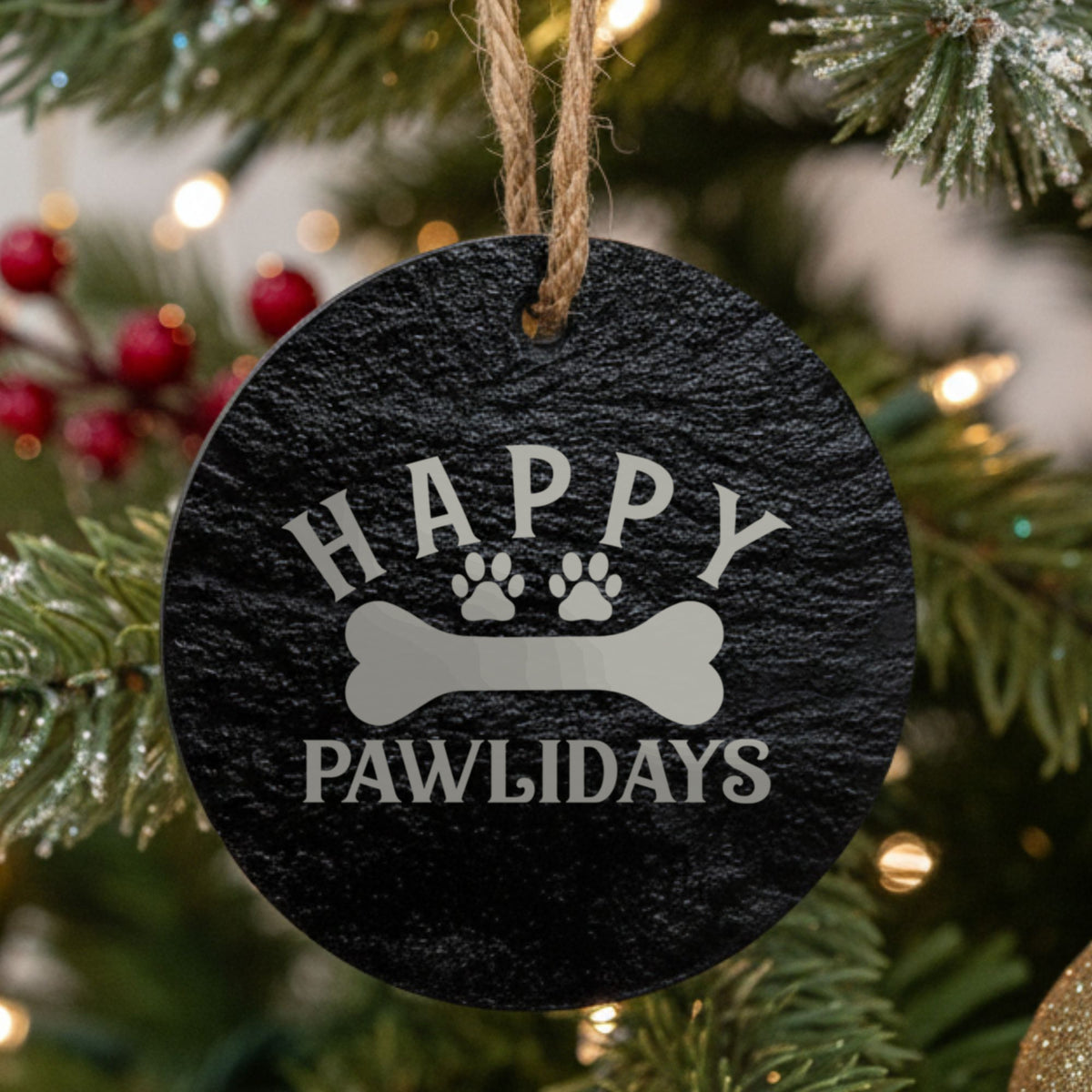 Round black slate Christmas ornament, laser engraved in white with Happy Pawlidays and a dog bone
