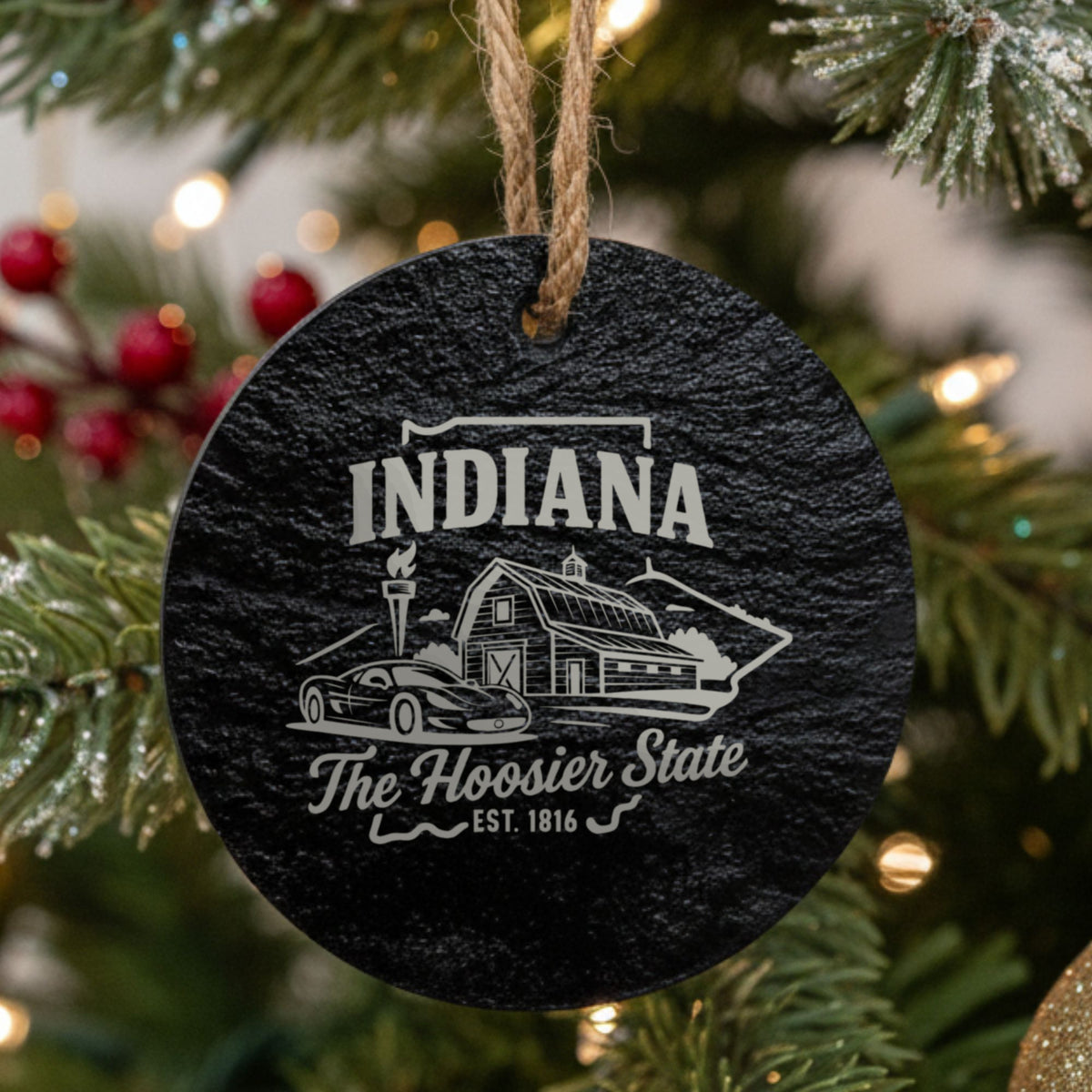 Round slate Christmas ornament laser engraved with an Indiana design of a red barn, a race car and a torch