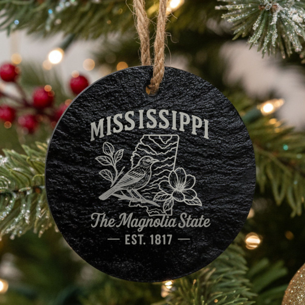 Round slate Christmas ornament laser engraved with a Mississippi design of a mockingbird and magnolia blossoms