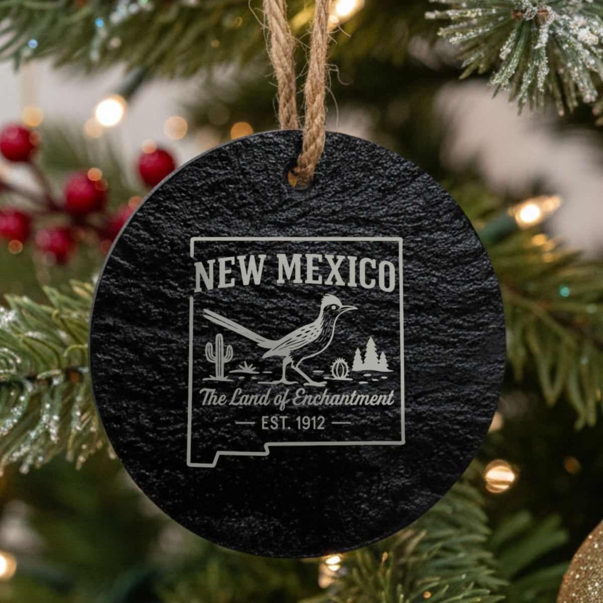 Round slate Christmas ornament laser engraved with a New Mexico design of a roadrunner, cactus and pines
