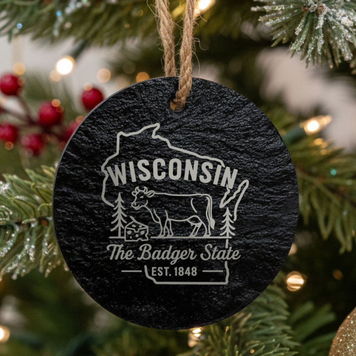 Round slate Christmas ornament laser engraved with a Wisconsin design of a dairy cow and a wedge of cheese
