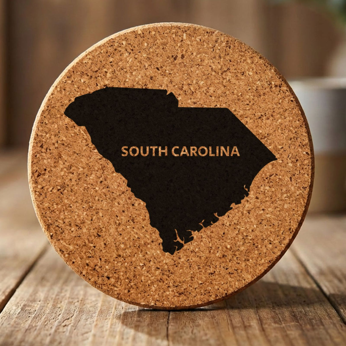 South Carolina round cork coaster engraved with the state shape and SOUTH CAROLINA in bold lettering