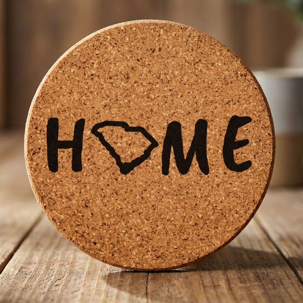 South Carolina round cork coaster engraved with HOME using the state outline as the letter O