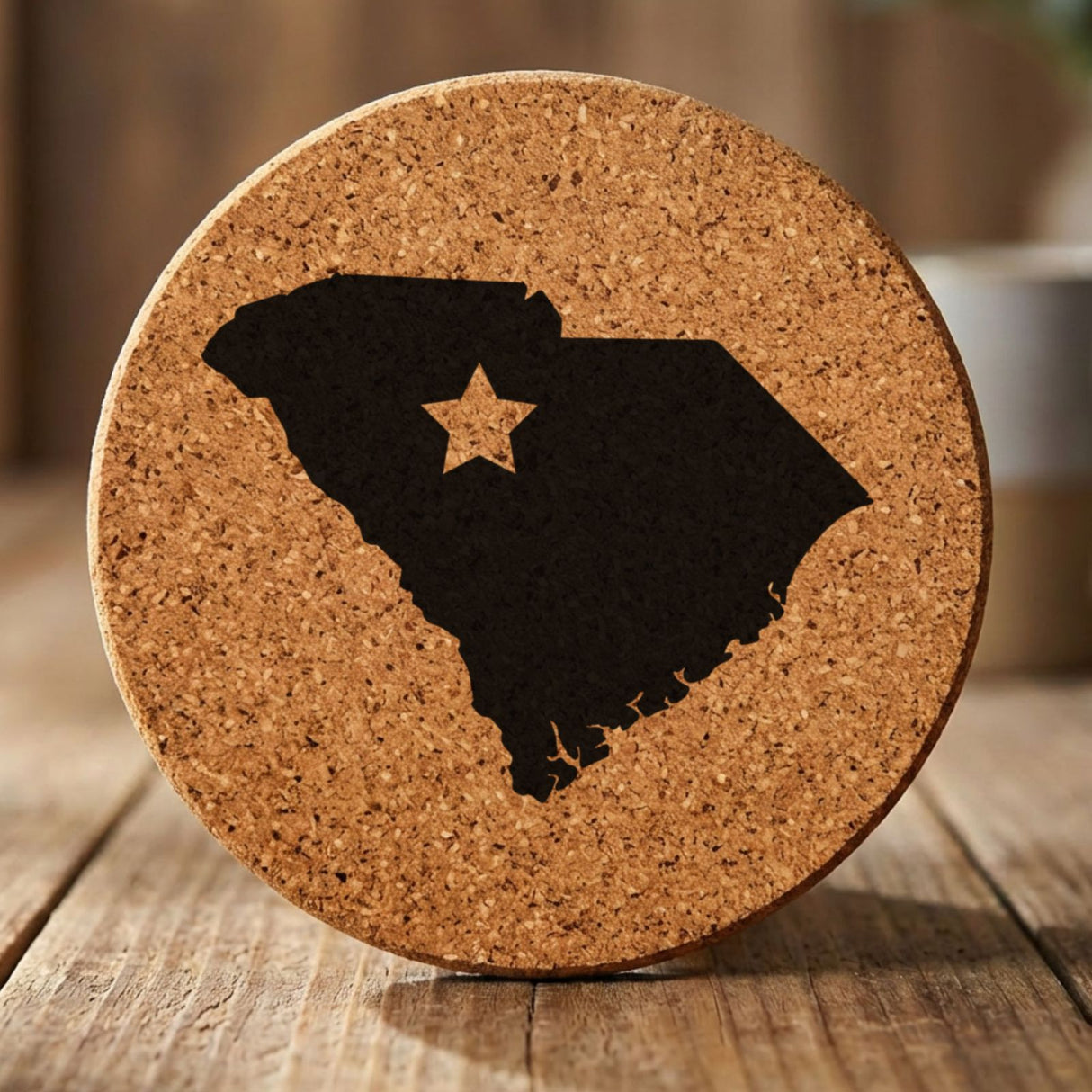 South Carolina round cork coaster engraved with the state shape and a star