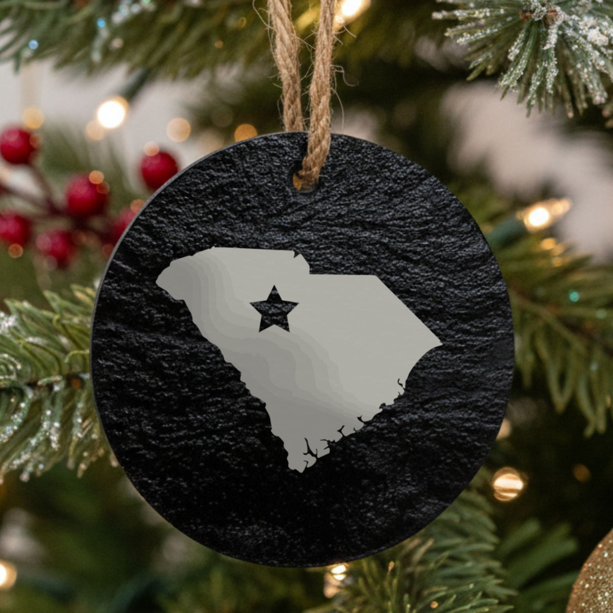 South Carolina round slate Christmas ornament engraved with the state shape and a star