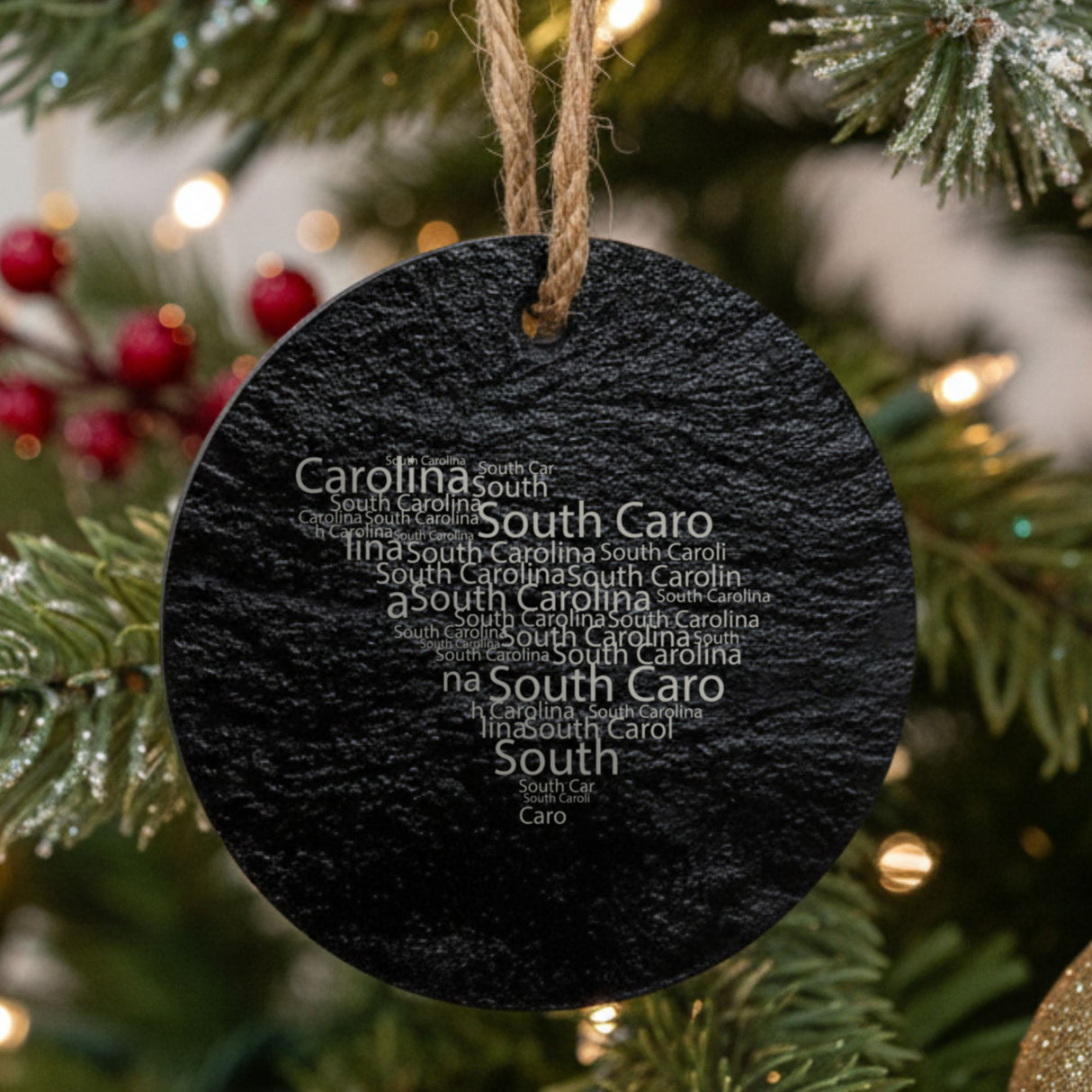 South Carolina round slate Christmas ornament engraved with a word cloud of repeating South Carolina text