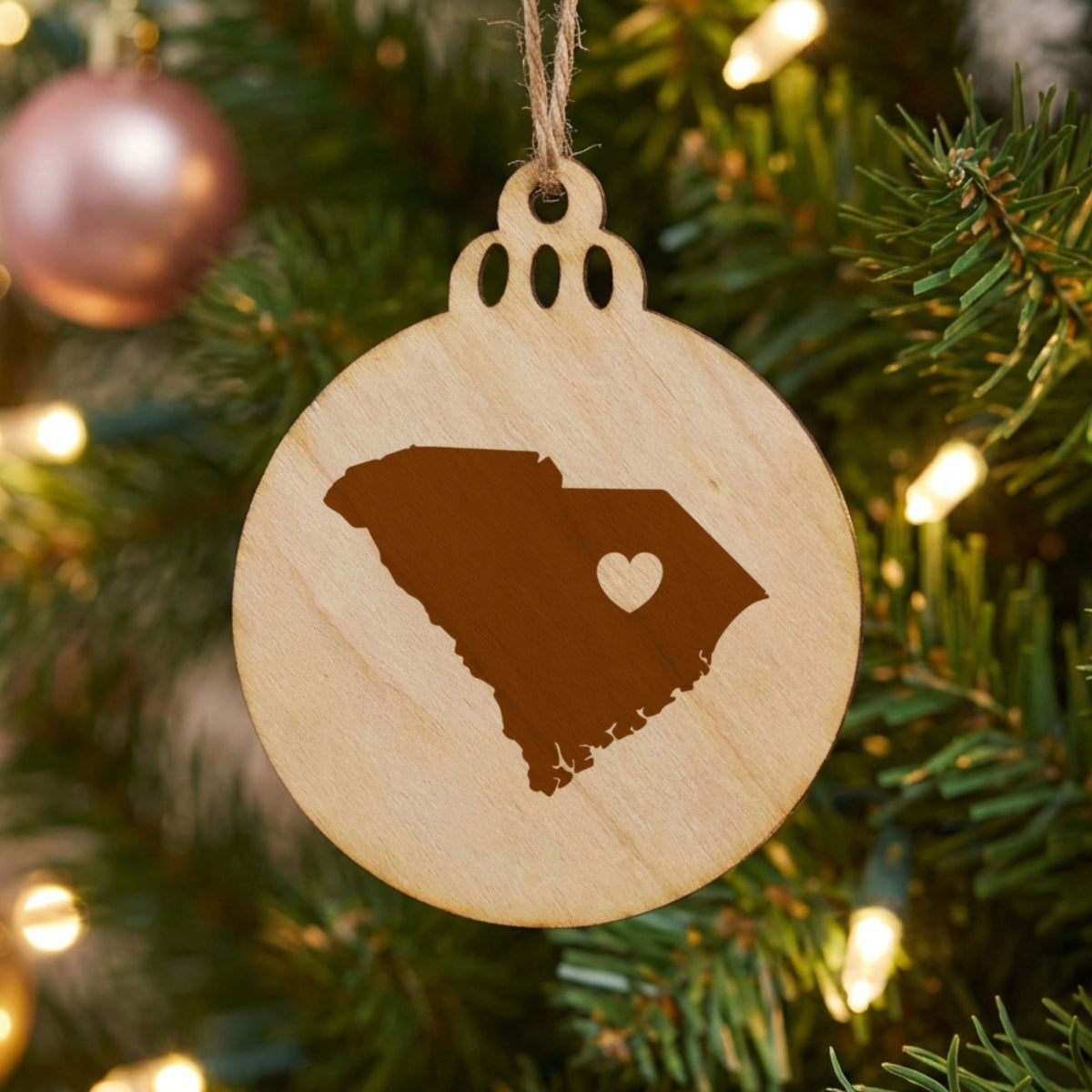 South Carolina round wood Christmas ornament engraved with the state shape and a heart