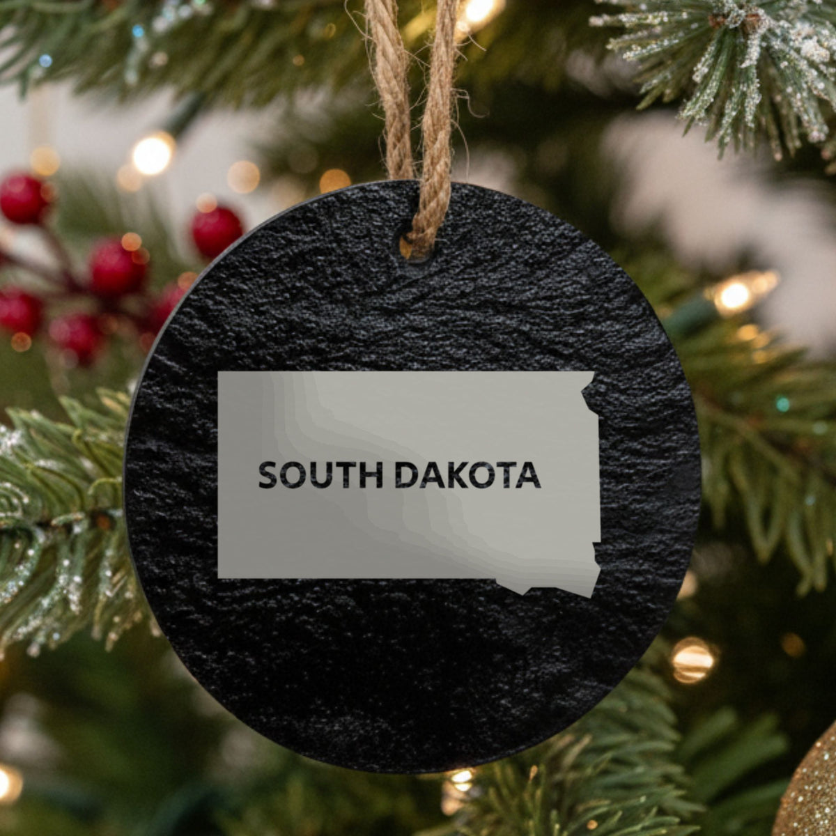 South Dakota round slate Christmas ornament engraved with the state shape and SOUTH DAKOTA in bold lettering