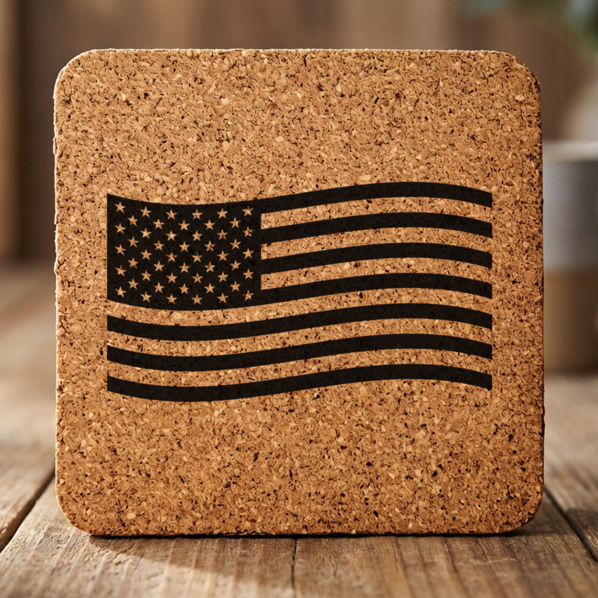 Square cork coaster laser engraved with an American flag, waving design