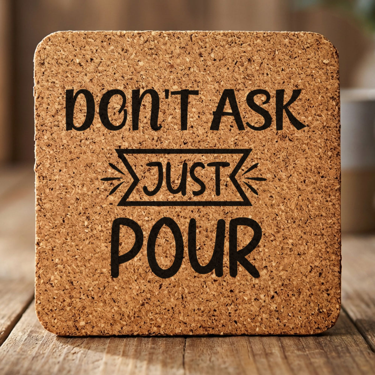 Square cork coaster laser engraved with "Don't Ask, Just Pour", banner design