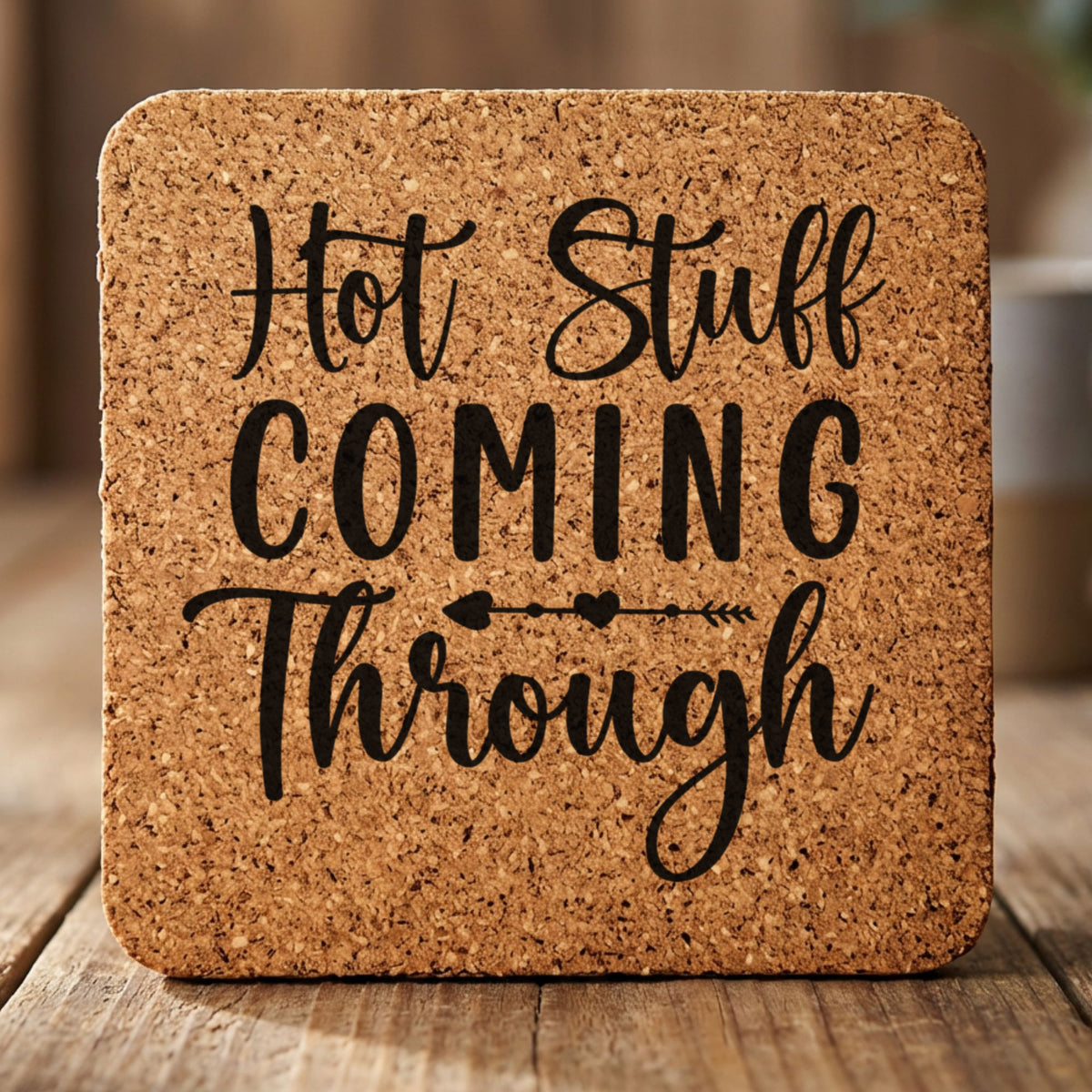 Square cork coaster laser engraved with "Hot Stuff Coming Through"