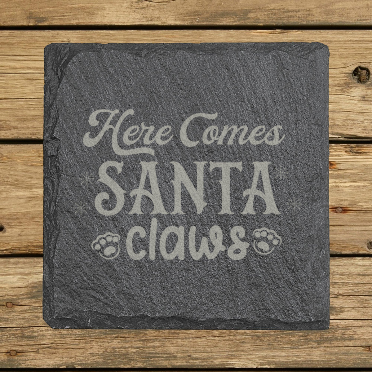 Square slate coaster laser engraved with "Here Comes Santa Claws"