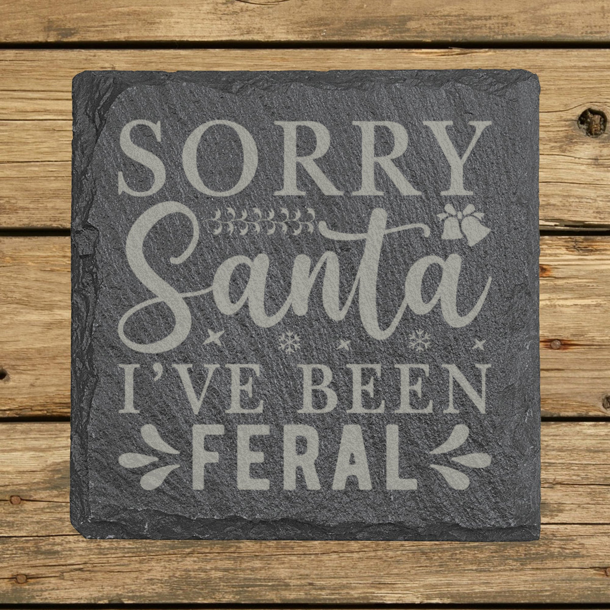 Square slate coaster laser engraved with "Sorry Santa, I've Been Feral"