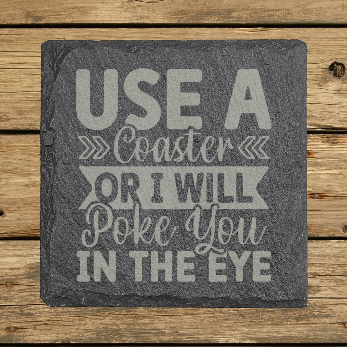 Square slate coaster laser engraved with "Use a Coaster or I Will Poke You in the Eye", hand lettered design