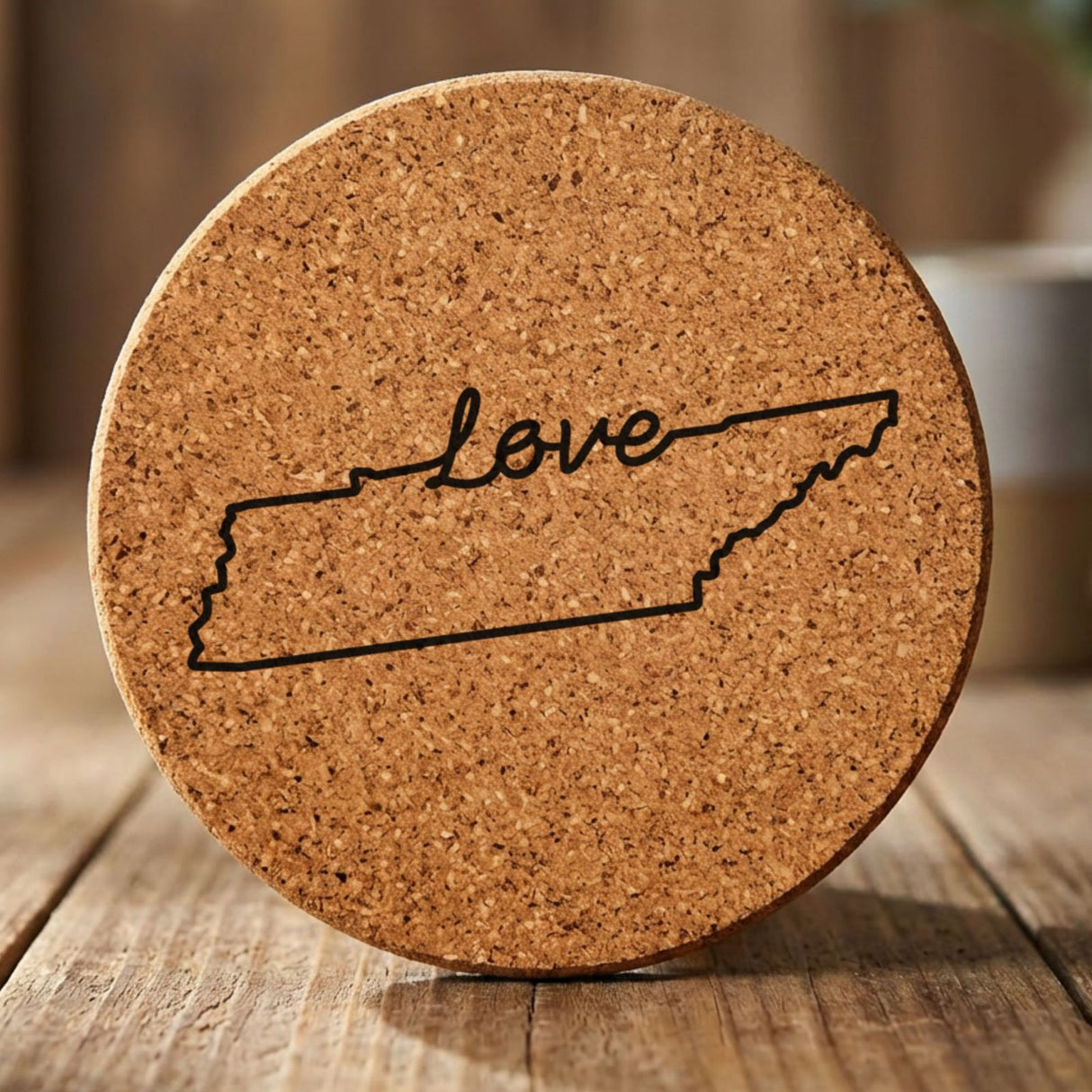 Tennessee round cork coaster engraved with a hand-drawn state outline and love in cursive
