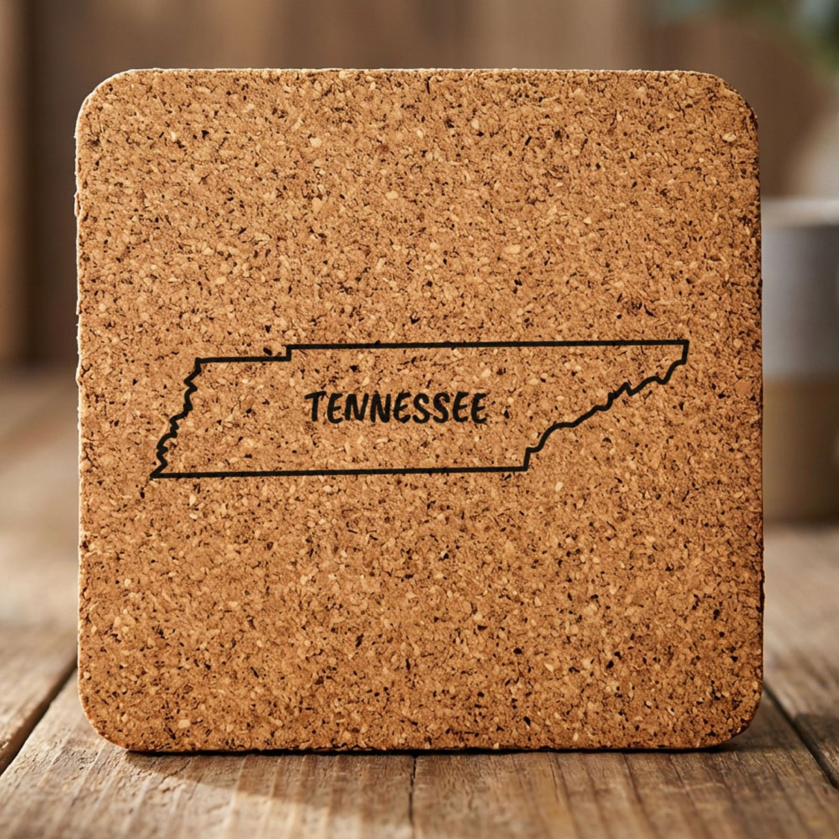Tennessee square cork coaster engraved with the state outline and TENNESSEE in hand-drawn brush lettering