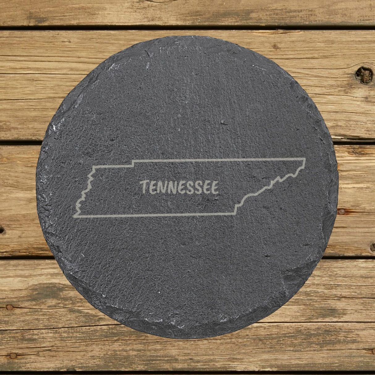 Tennessee round slate coaster engraved with the state outline and TENNESSEE in hand-drawn brush lettering