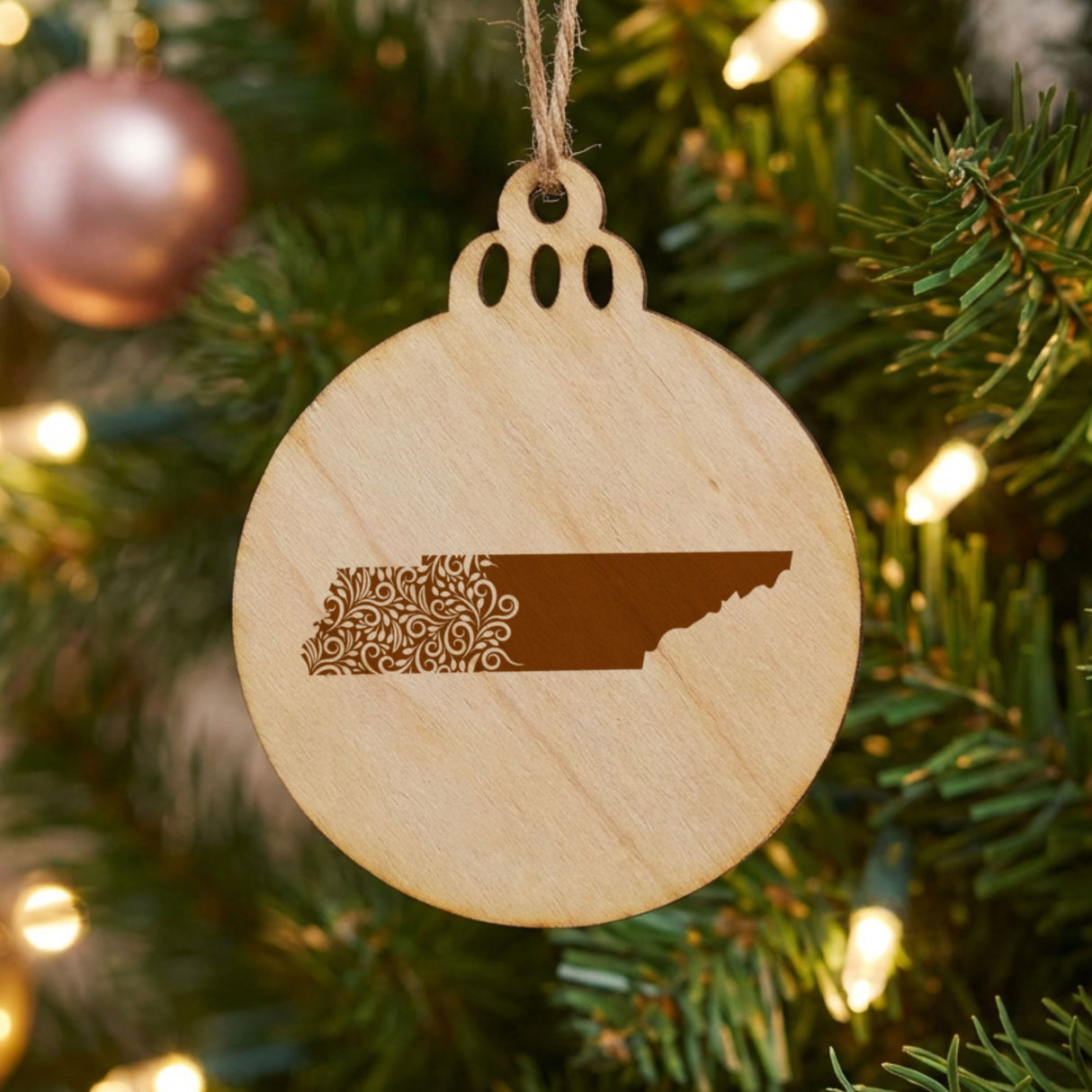Tennessee round wood Christmas ornament engraved with the state shape in ornate floral scrollwork