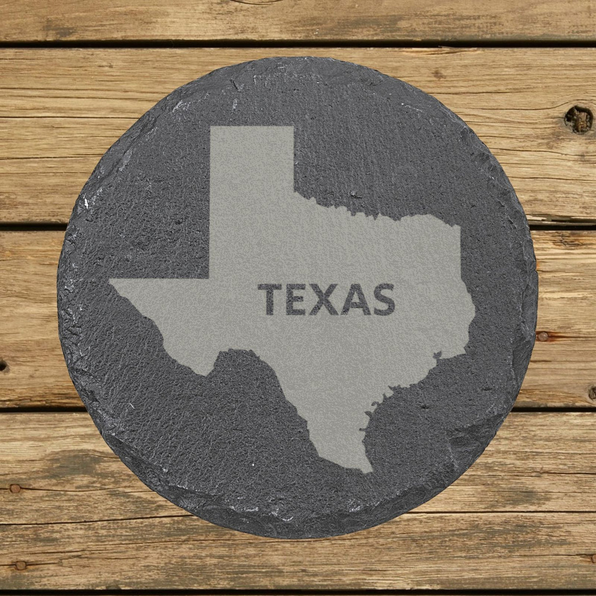 Texas round slate coaster engraved with the state shape and TEXAS in bold lettering