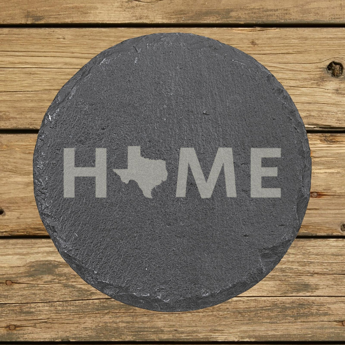 Texas round slate coaster engraved with HOME using the state outline as the letter O