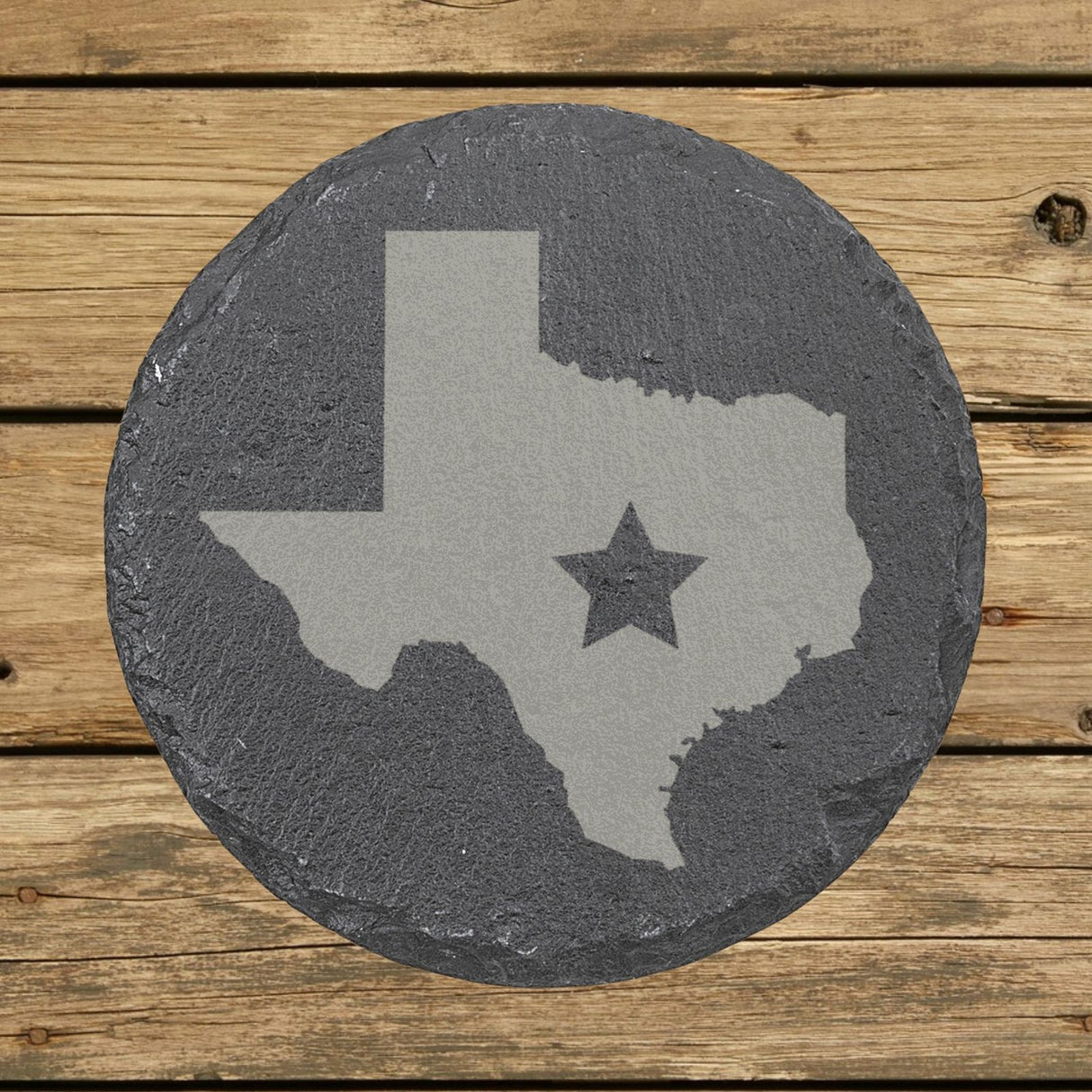 Texas round slate coaster engraved with the state shape and a star
