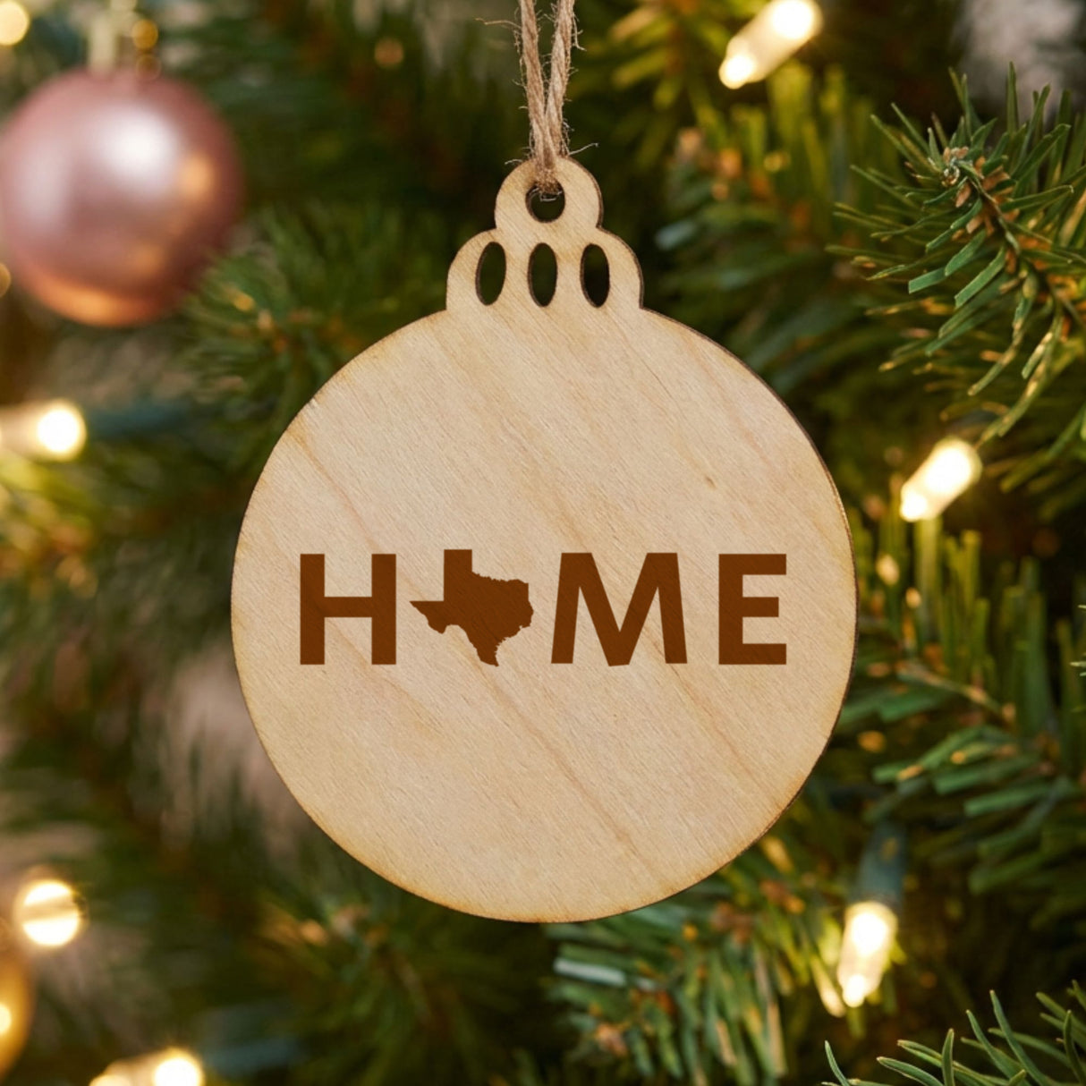 Texas round wood Christmas ornament engraved with HOME using the state outline as the letter O
