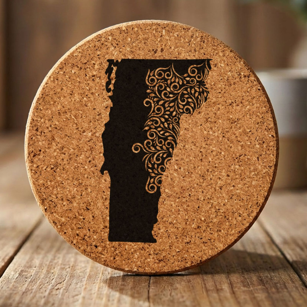 Vermont round cork coaster engraved with the state shape in ornate floral scrollwork