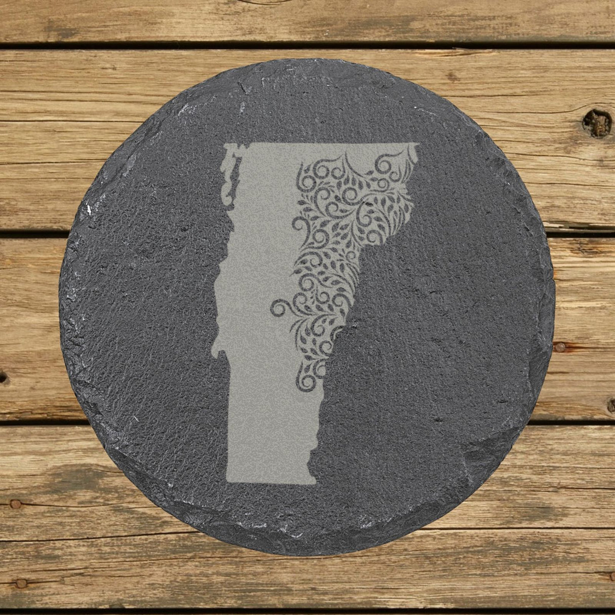 Vermont round slate coaster engraved with the state shape in ornate floral scrollwork