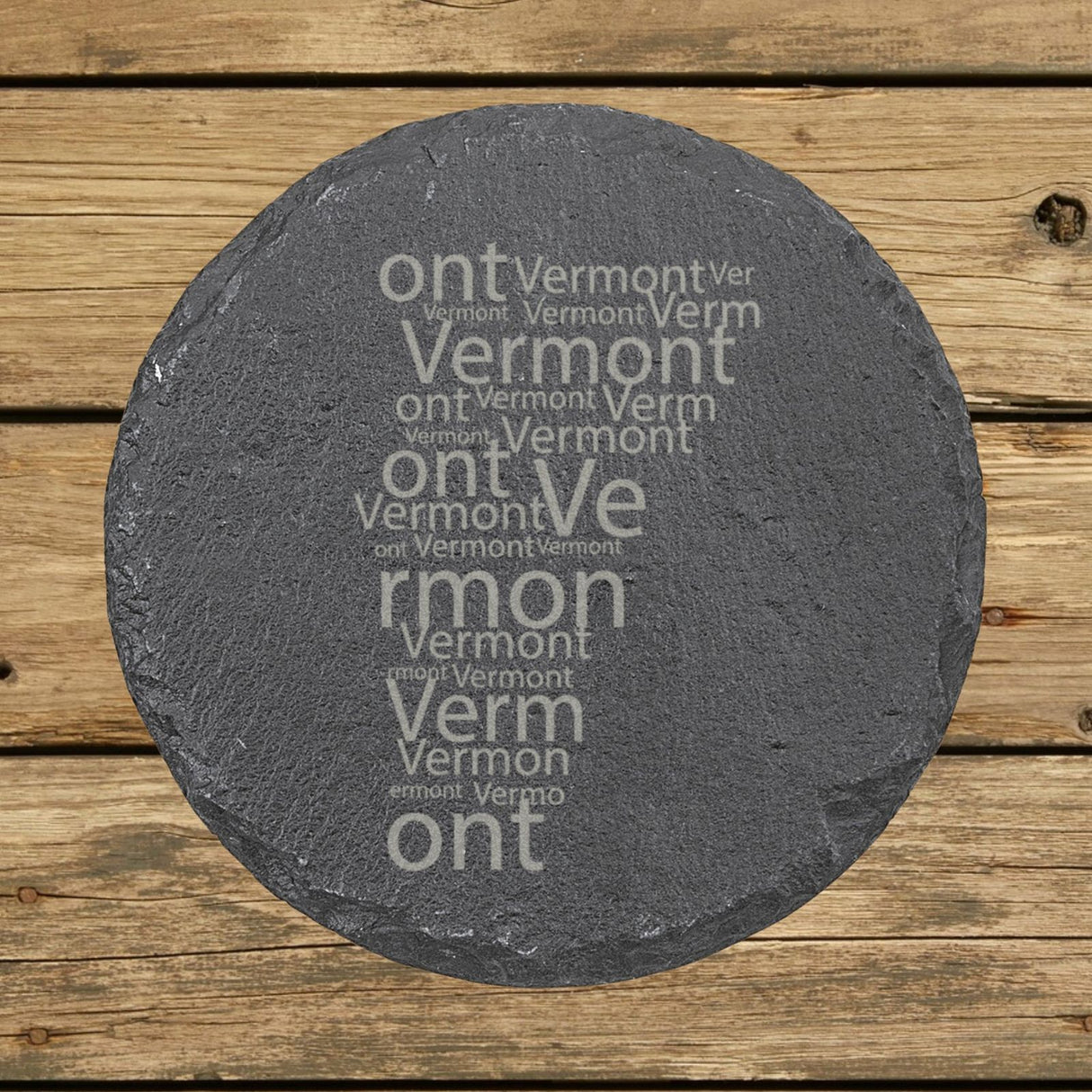 Vermont round slate coaster engraved with a word cloud of repeating Vermont text