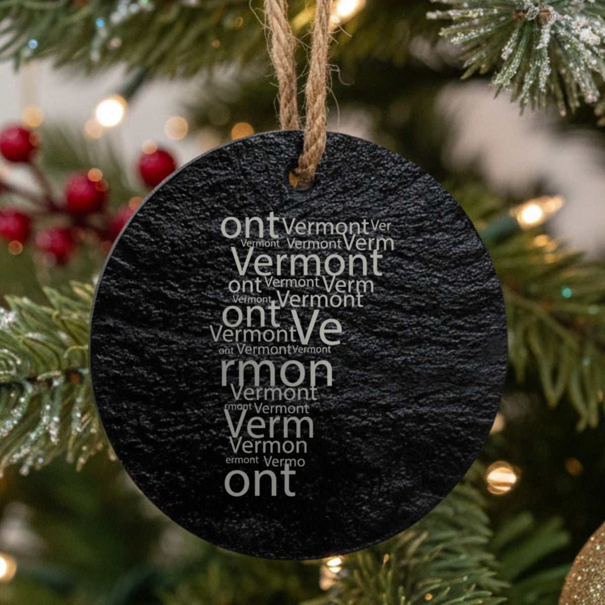 Vermont round slate Christmas ornament engraved with a word cloud of repeating Vermont text