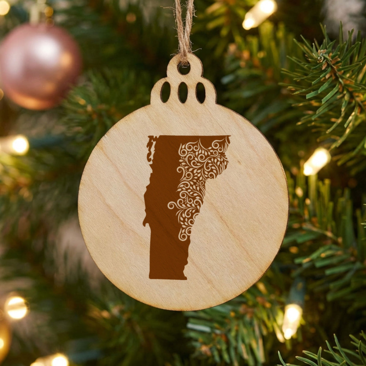 Vermont round wood Christmas ornament engraved with the state shape in ornate floral scrollwork
