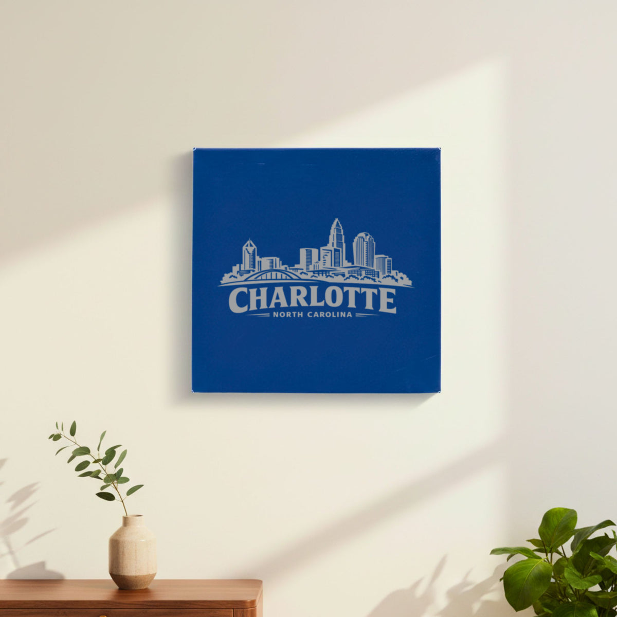 Blue leatherette wall sign engraved with the Charlotte, North Carolina skyline, hanging on a wall