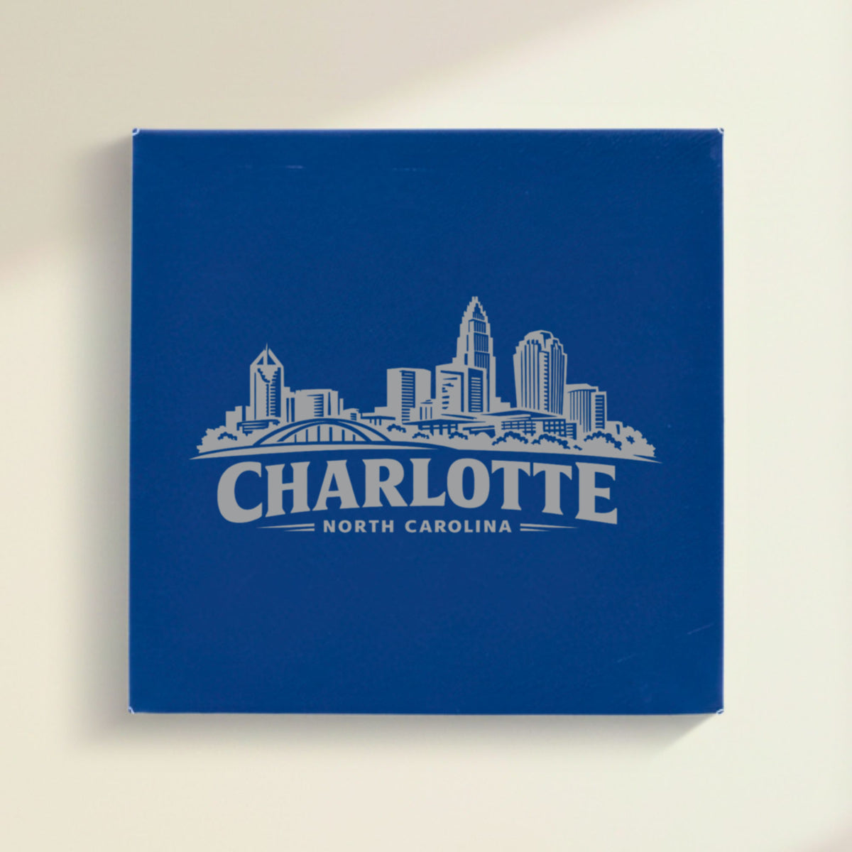 Close up of the Charlotte, North Carolina skyline engraved on Blue leatherette