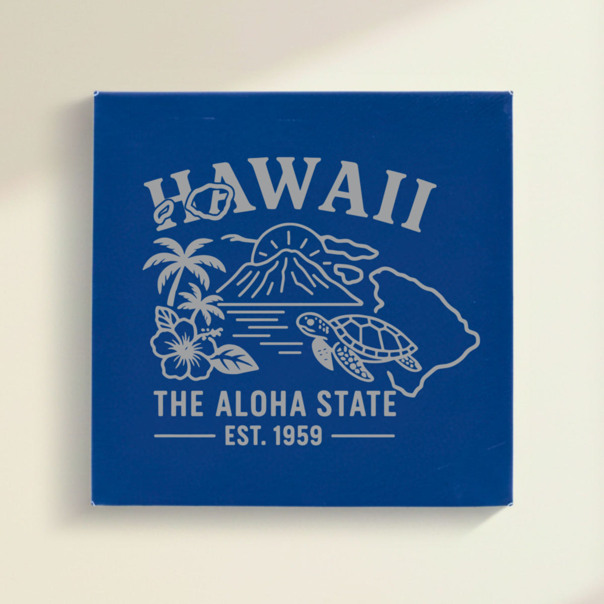 Close up of the Hawaii design engraved on Blue leatherette: a volcano, palm trees, a hibiscus and a sea turtle, "The Aloha State", EST. 1959