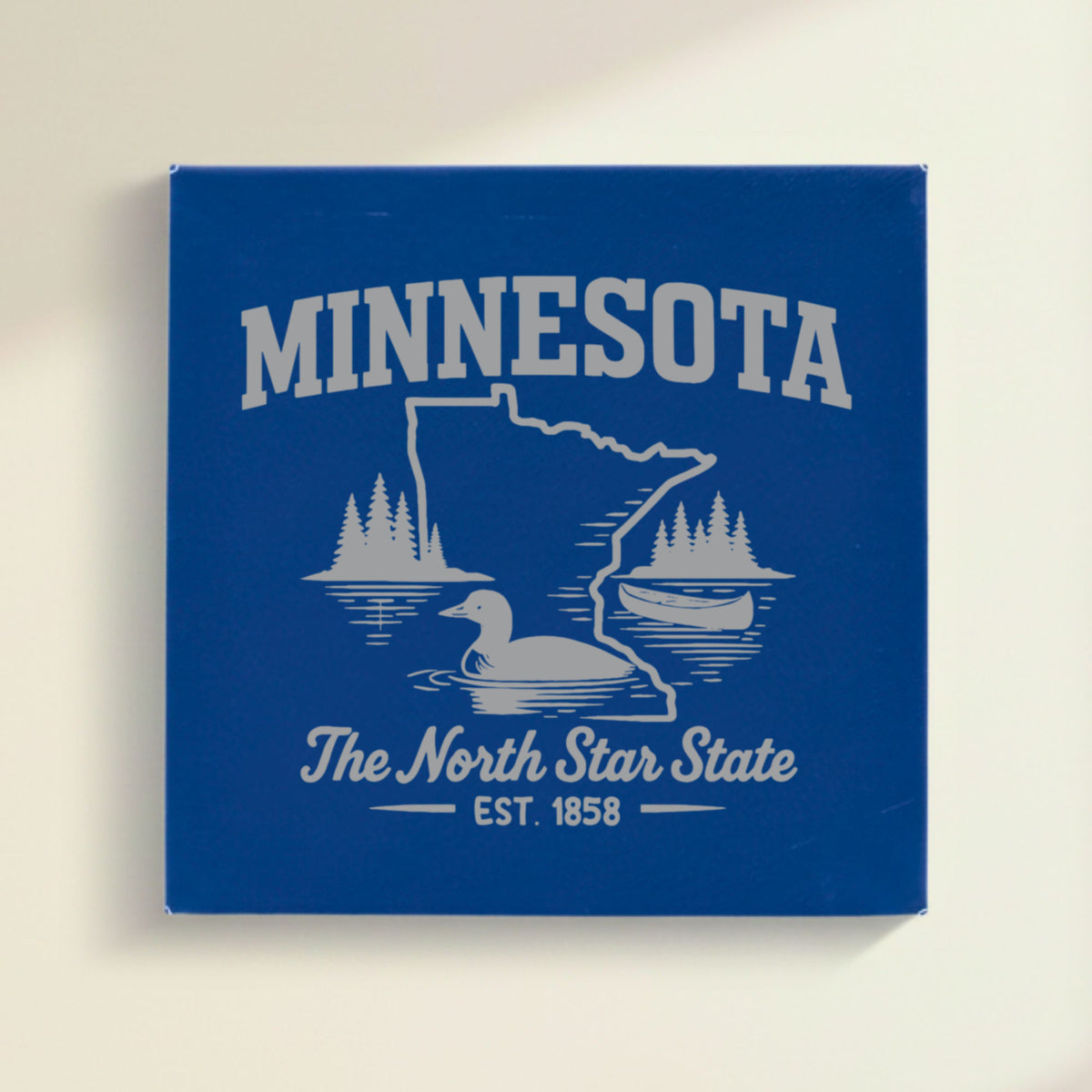 Close up of the Minnesota design engraved on Blue leatherette: a loon, a canoe and lakeside pines, "The North Star State", EST. 1858
