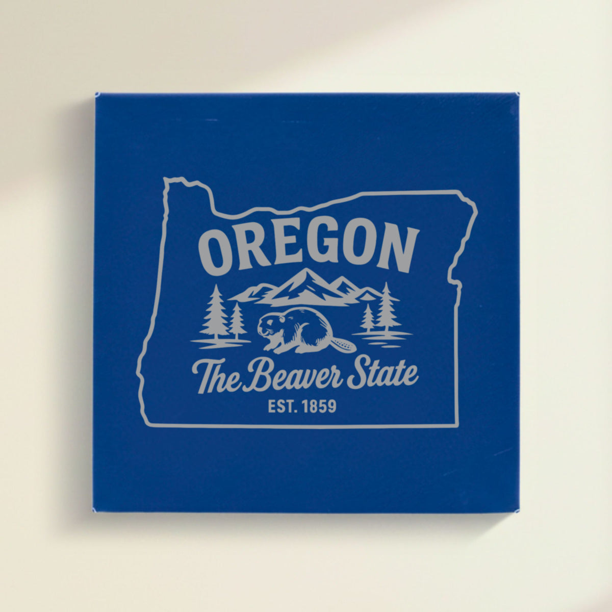 Close up of the Oregon design engraved on Blue leatherette: a beaver, mountains and pines, "The Beaver State", EST. 1859