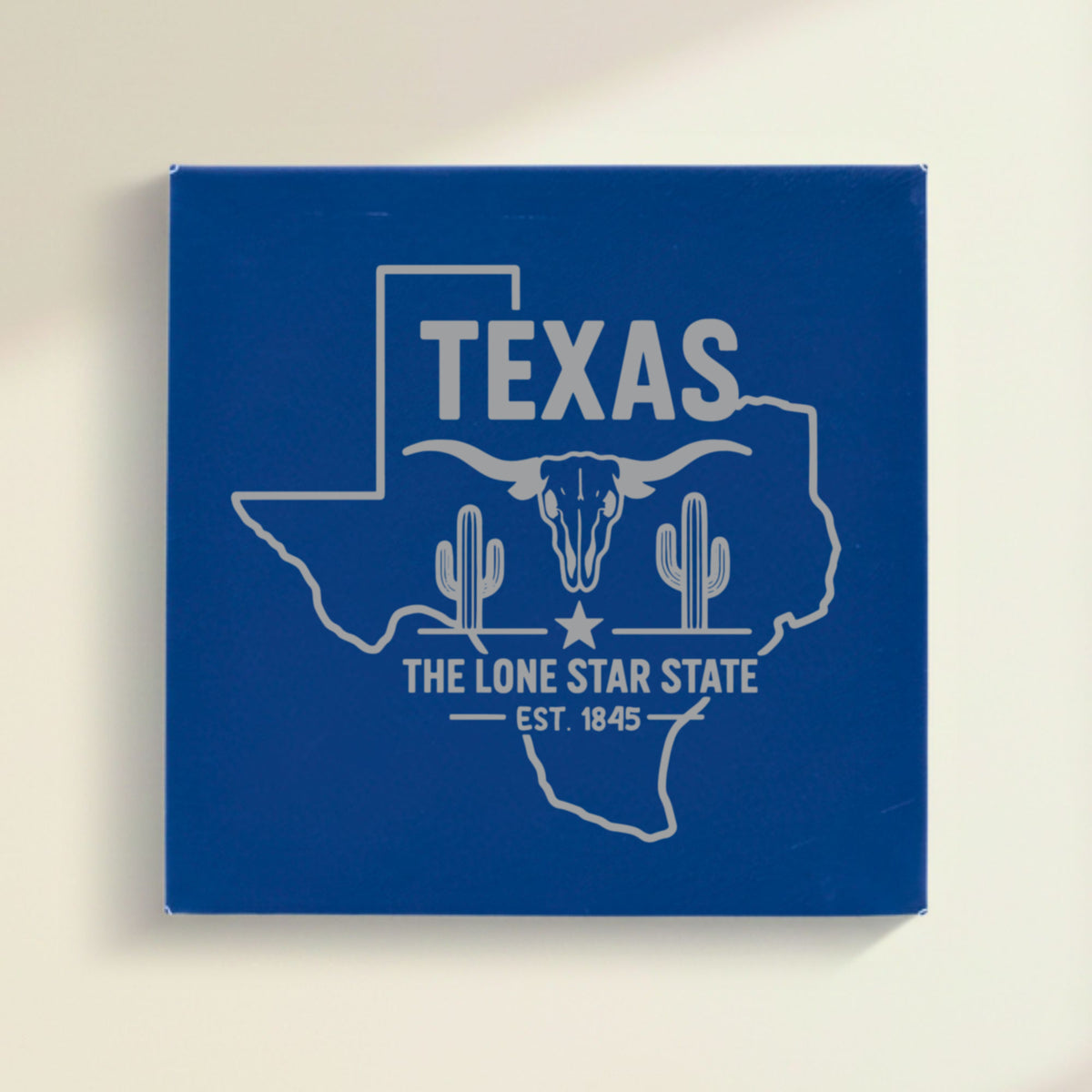 Close up of the Texas design engraved on Blue leatherette: a longhorn skull, cactus and a lone star, "The Lone Star State", EST. 1845