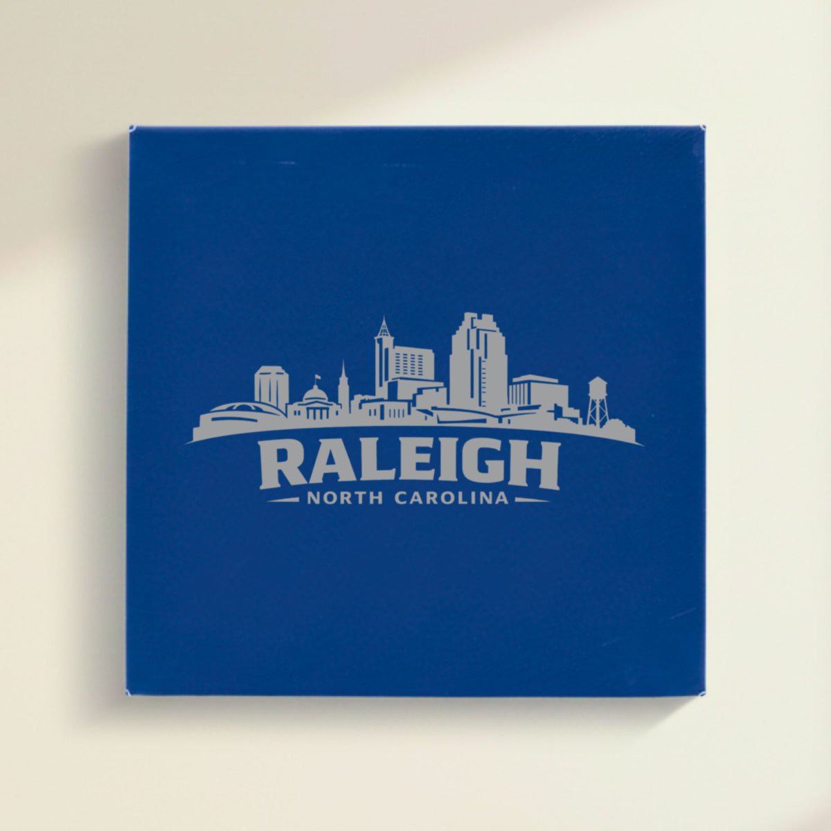 Close up of the Raleigh, North Carolina skyline engraved on Blue leatherette