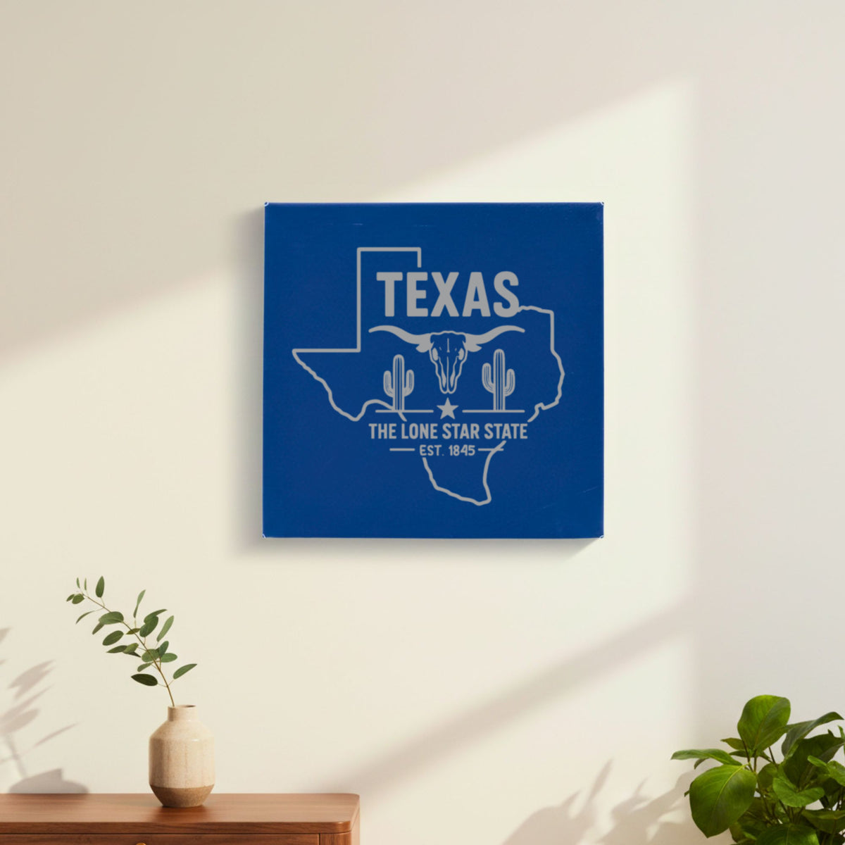 Blue leatherette wall sign engraved with a Texas design of a longhorn skull, cactus and a lone star, hanging on a wall