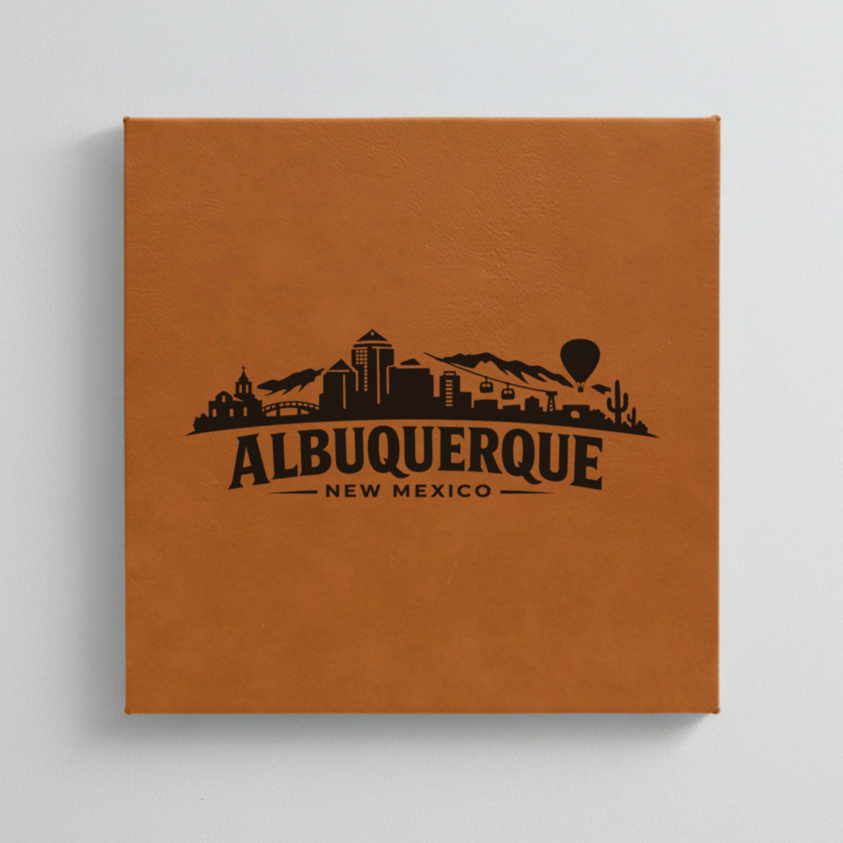 Close up of the Albuquerque, New Mexico skyline engraved on Brown leatherette