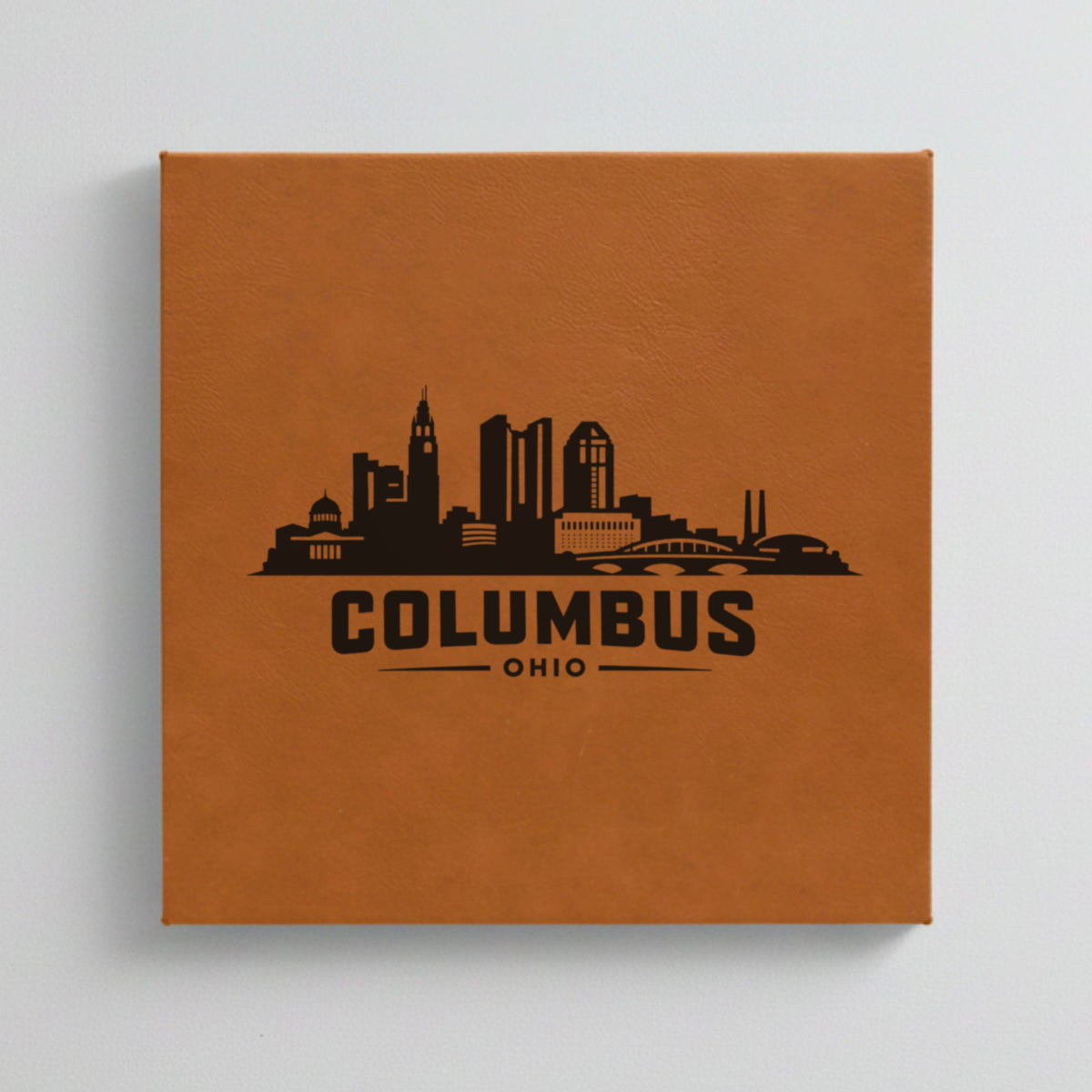 Close up of the Columbus, Ohio skyline engraved on Brown leatherette