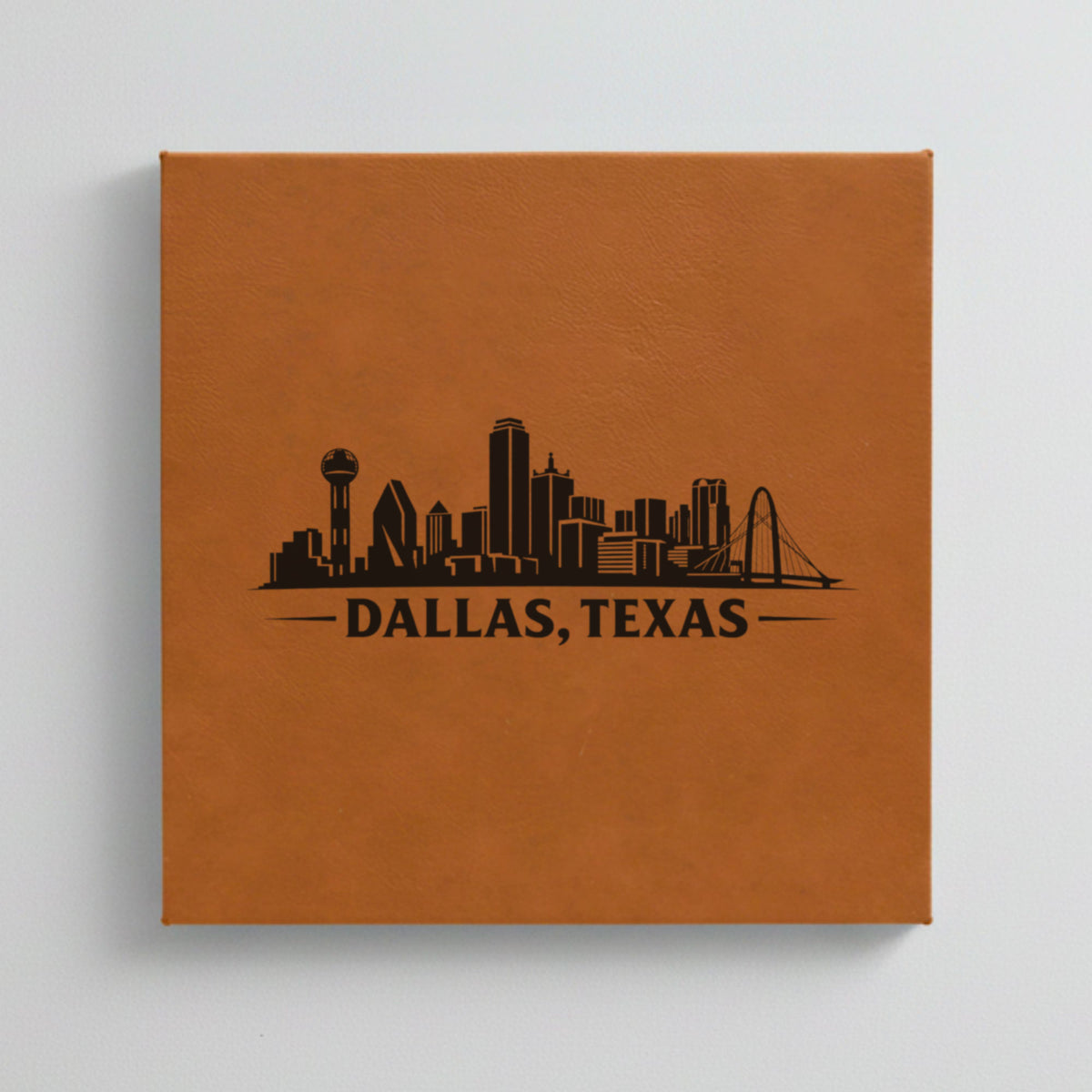 Close up of the Dallas, Texas skyline engraved on Brown leatherette