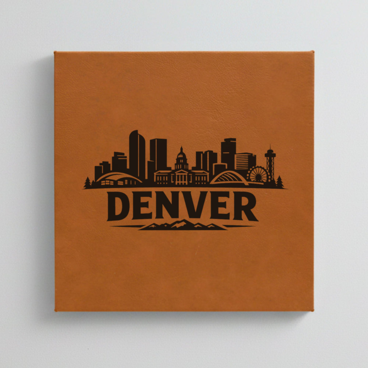 Close up of the Denver, Colorado skyline engraved on Brown leatherette