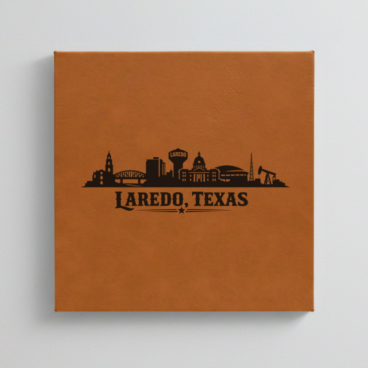 Close up of the Laredo, Texas skyline engraved on Brown leatherette
