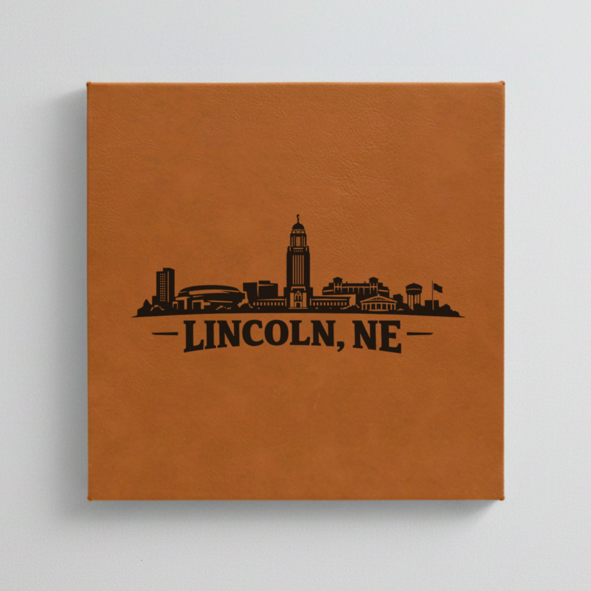 Close up of the Lincoln, Nebraska skyline engraved on Brown leatherette