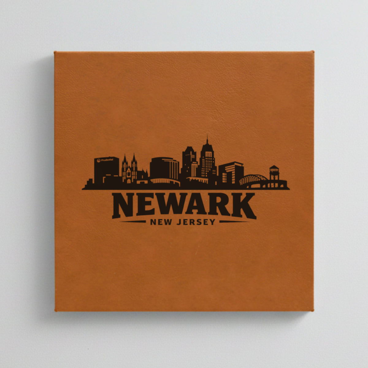 Close up of the Newark, New Jersey skyline engraved on Brown leatherette