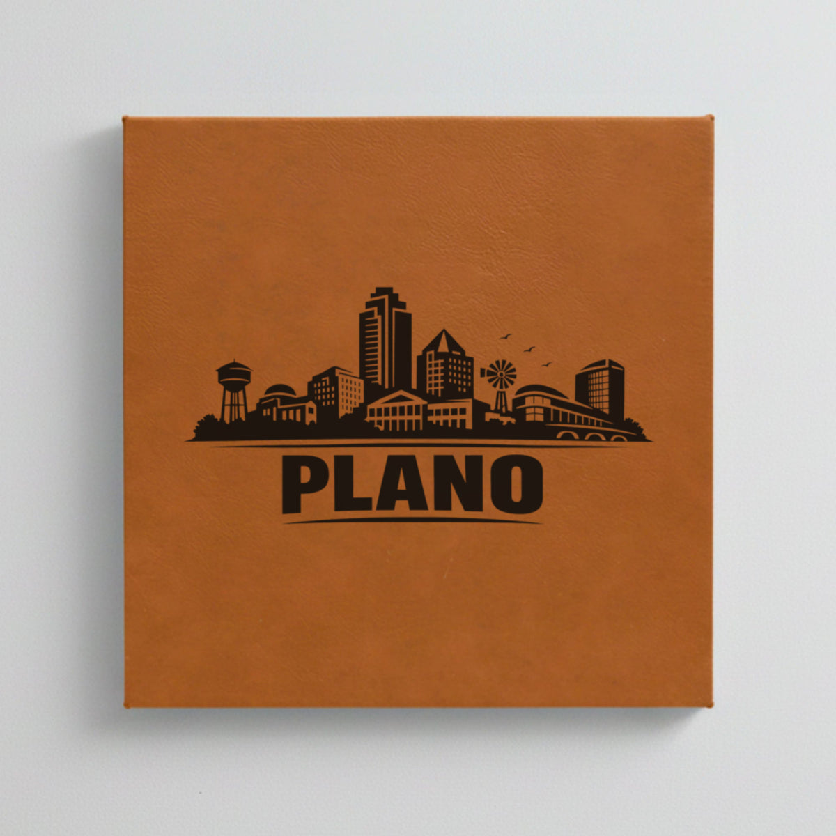 Close up of the Plano, Texas skyline engraved on Brown leatherette